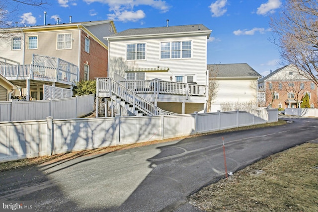 back of house with stairway, a residential view, and fence