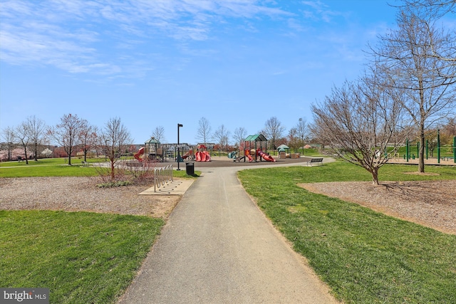 surrounding community with playground community and a lawn