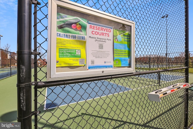 view of sport court featuring fence