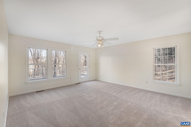 carpeted spare room with ceiling fan