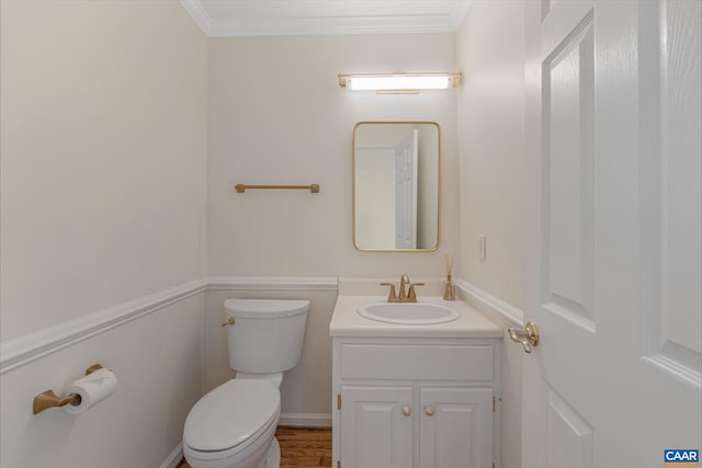 bathroom featuring ornamental molding, vanity, and toilet