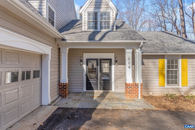 doorway to property with a garage