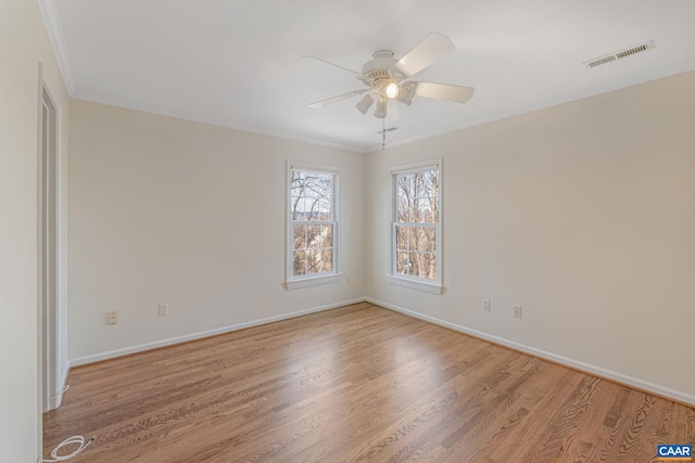 spare room with ceiling fan, ornamental molding, and light hardwood / wood-style floors