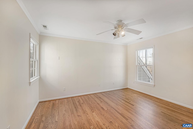 empty room with crown molding, ceiling fan, and light hardwood / wood-style floors