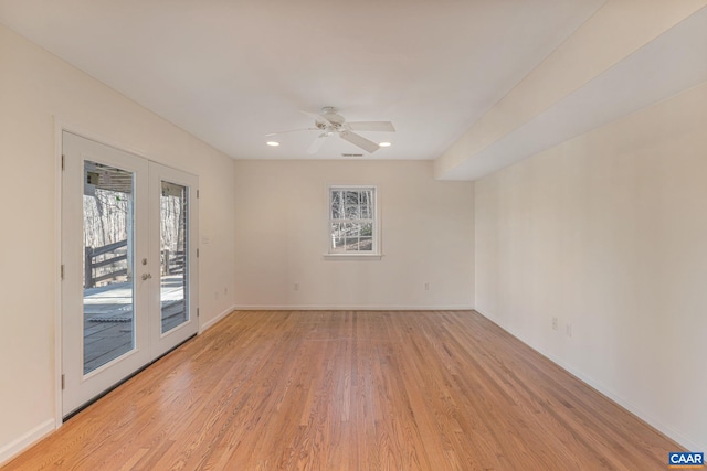 empty room featuring french doors, ceiling fan, and light hardwood / wood-style floors