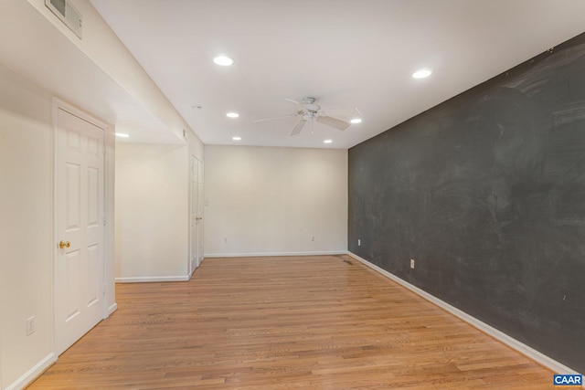 spare room featuring ceiling fan and light hardwood / wood-style floors