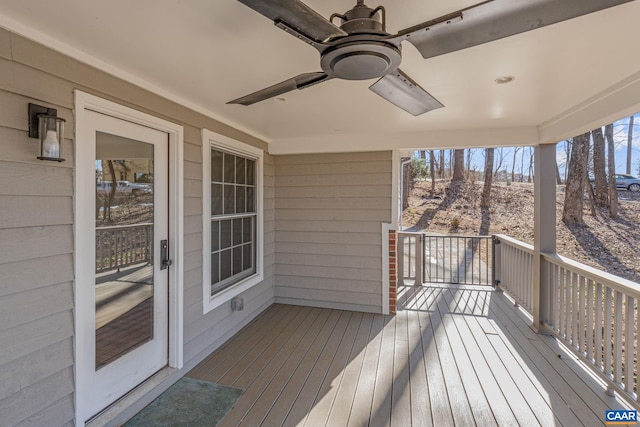 wooden terrace featuring ceiling fan