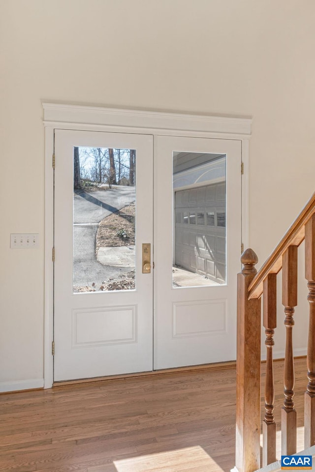 entryway featuring french doors and wood-type flooring