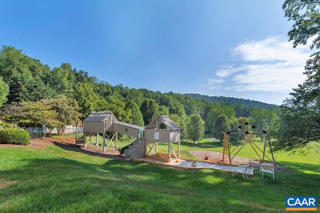 view of playground with a lawn