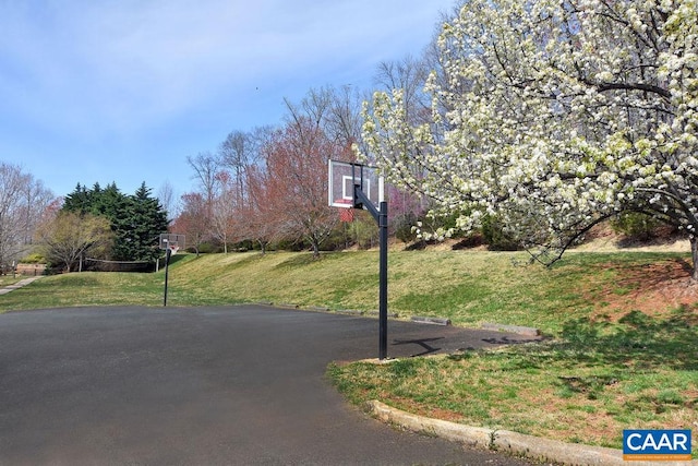 view of basketball court with a lawn