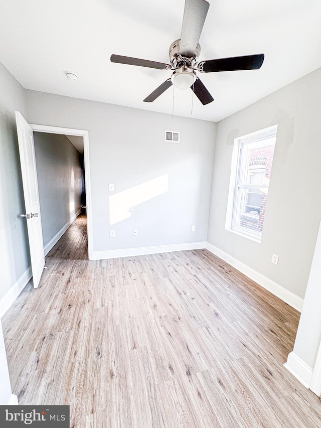 spare room featuring ceiling fan and light hardwood / wood-style flooring