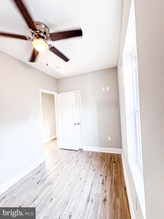 empty room with light hardwood / wood-style flooring and ceiling fan