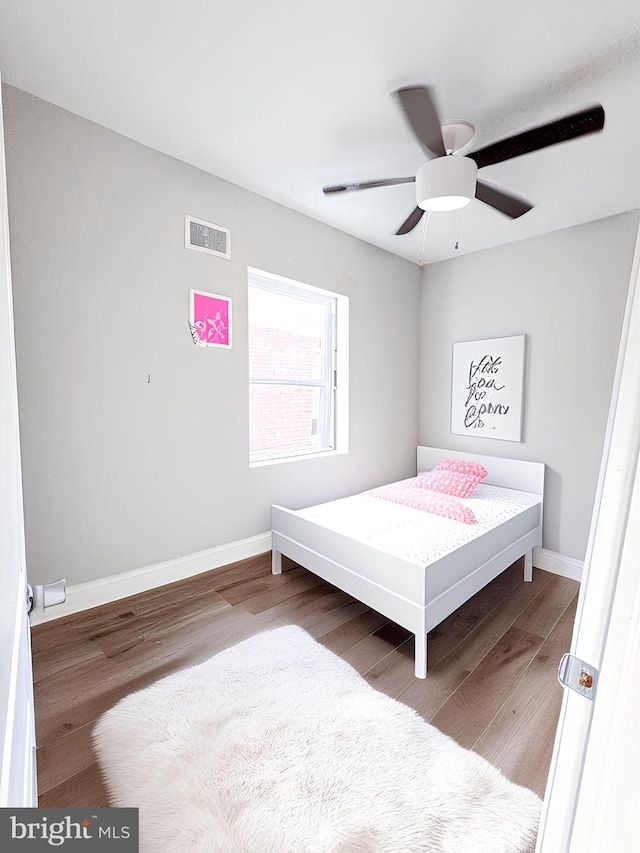 bedroom with wood-type flooring and ceiling fan