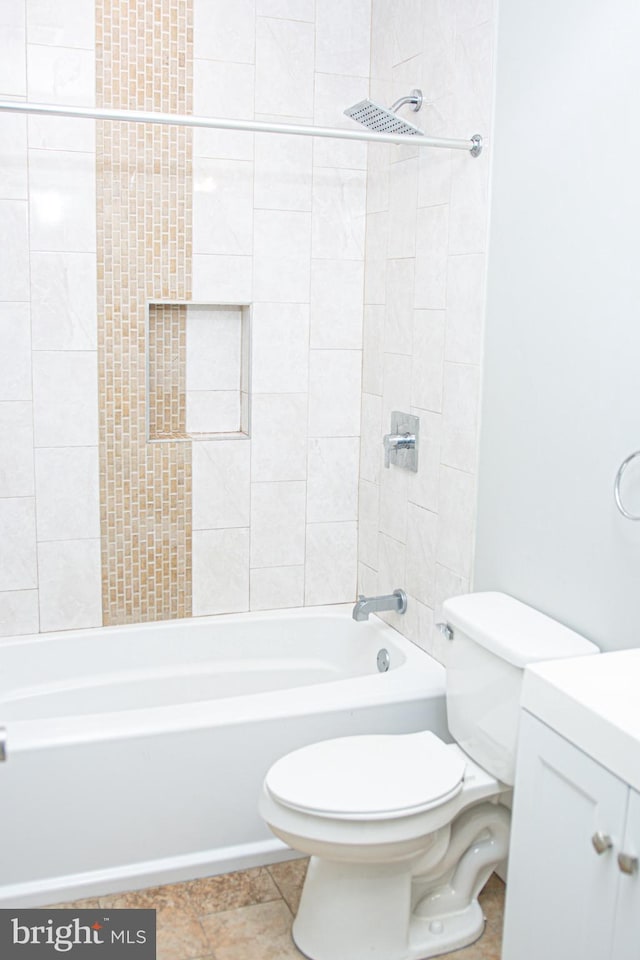 full bathroom with vanity, tile patterned flooring, tiled shower / bath combo, and toilet