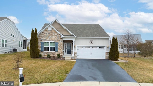 view of front of house featuring a garage, a front yard, and central air condition unit