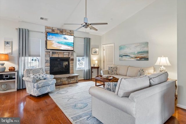 living room featuring wood-type flooring, lofted ceiling, a healthy amount of sunlight, and a fireplace