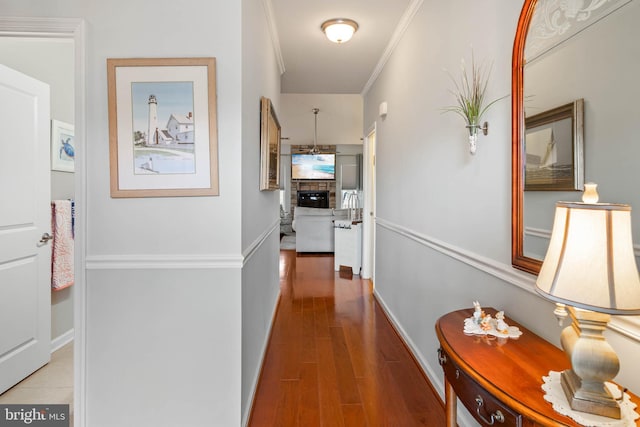 corridor featuring crown molding and hardwood / wood-style floors