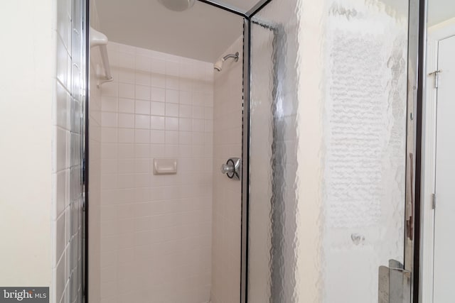 bathroom with a shower with door