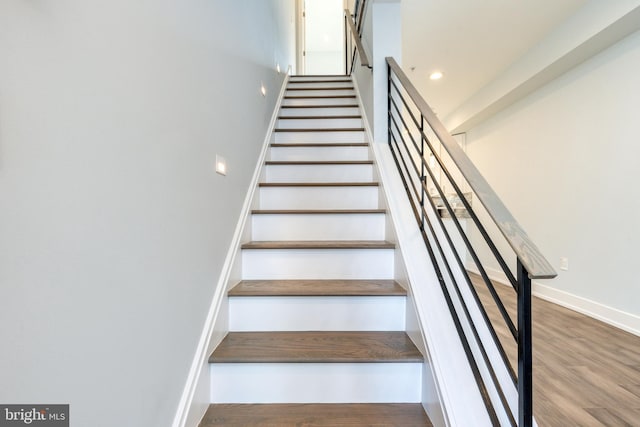 stairs with wood-type flooring