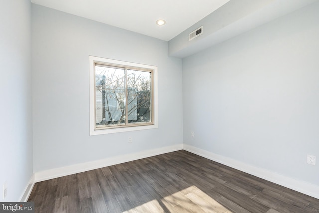 unfurnished room with dark hardwood / wood-style floors