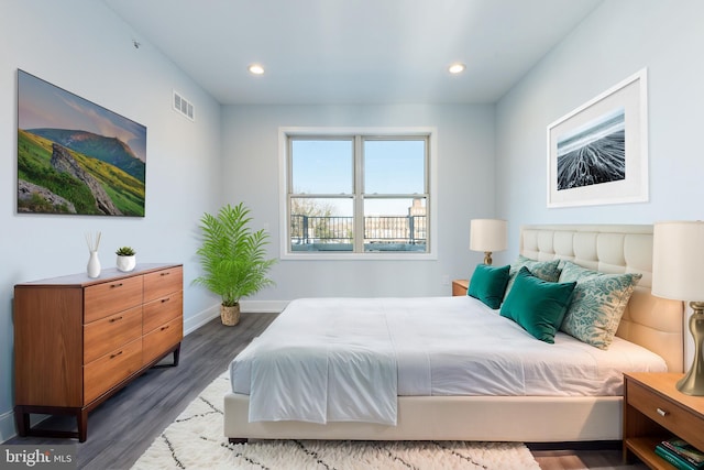 bedroom with dark hardwood / wood-style floors