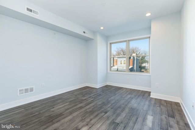 spare room featuring dark hardwood / wood-style flooring