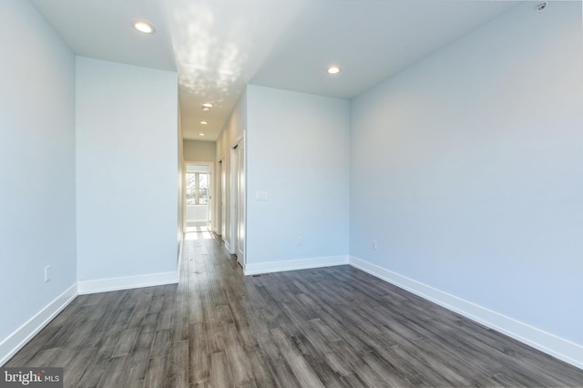 spare room with dark hardwood / wood-style floors