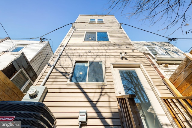 view of side of home with central AC