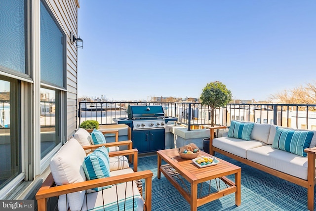 balcony featuring outdoor lounge area and a grill