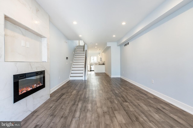 unfurnished living room with dark hardwood / wood-style floors and a fireplace