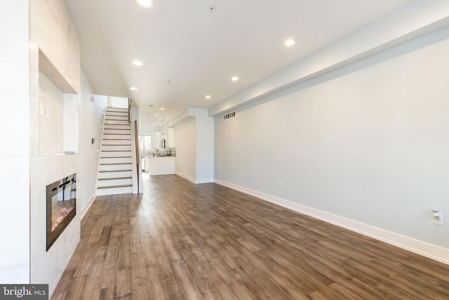 unfurnished living room with hardwood / wood-style flooring and a fireplace