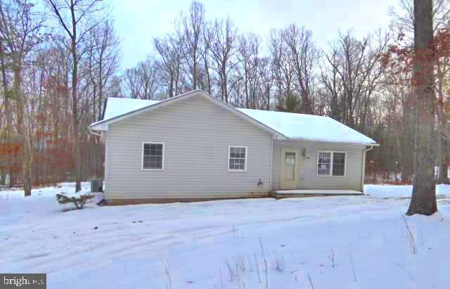 view of snow covered back of property