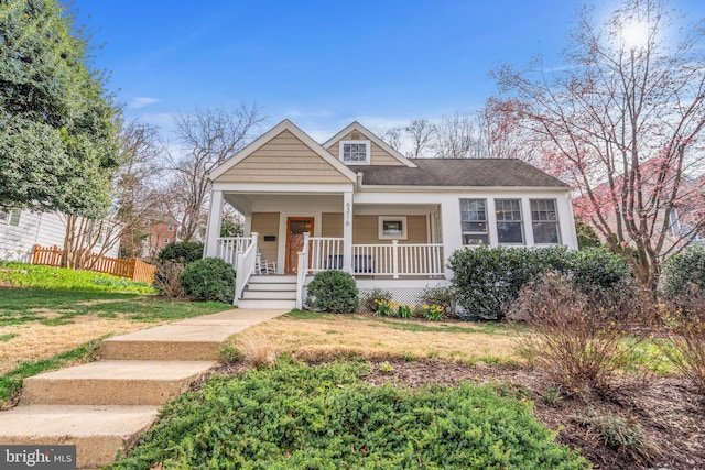 bungalow-style house featuring a front yard and covered porch