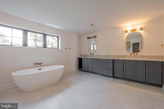 bathroom with vanity and a tub