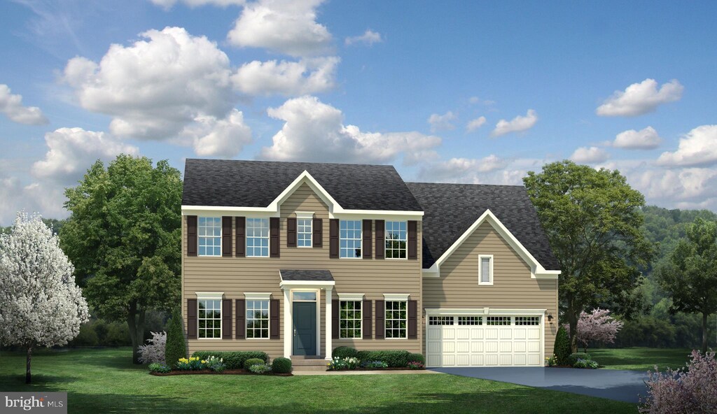 colonial home featuring a garage and a front yard