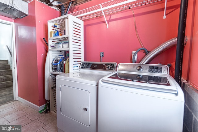 laundry room featuring tile patterned flooring and washer and dryer