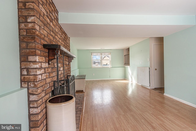 unfurnished living room featuring a fireplace and wood-type flooring