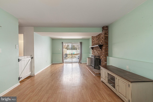 unfurnished living room featuring a fireplace and light wood-type flooring