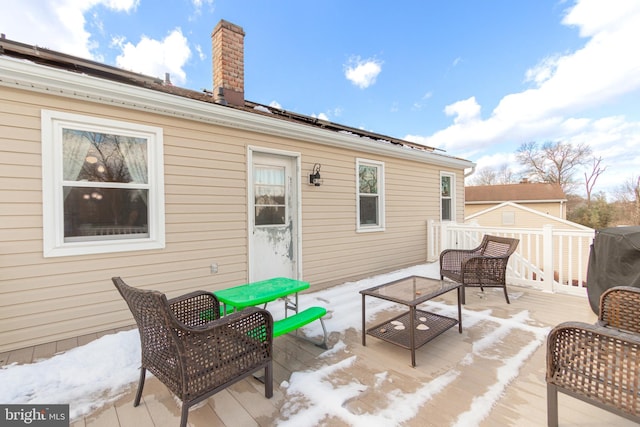 back of property featuring a wooden deck and an outdoor hangout area