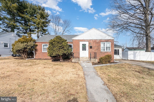 bungalow-style home with a front lawn