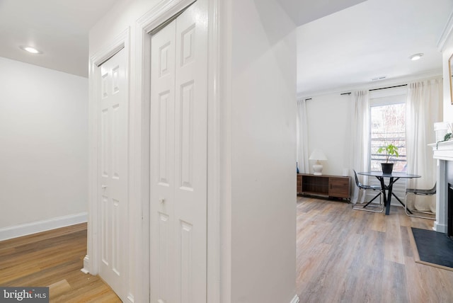 corridor with light hardwood / wood-style floors