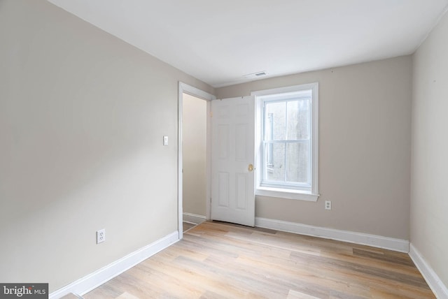 spare room with light wood-type flooring