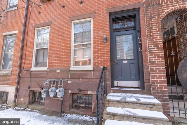 view of snow covered property entrance