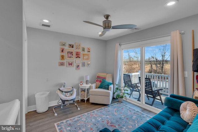 sitting room with ceiling fan and light hardwood / wood-style flooring