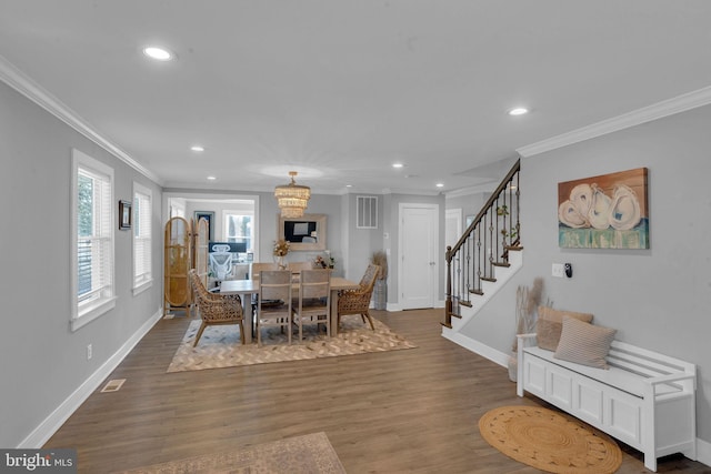 dining space featuring ornamental molding and dark hardwood / wood-style floors