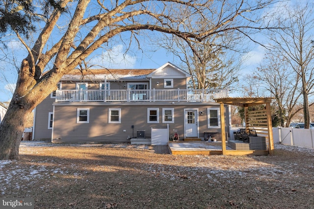 back of property with a wooden deck and a pergola