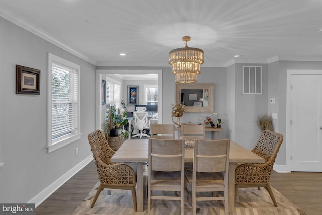 dining area with ornamental molding, dark hardwood / wood-style floors, and a notable chandelier