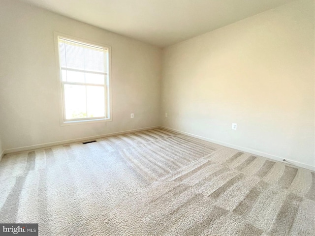 unfurnished room with light colored carpet