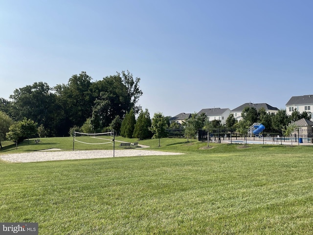 surrounding community featuring a yard and volleyball court