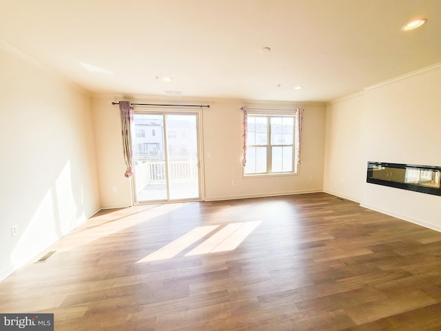 interior space featuring crown molding, hardwood / wood-style flooring, and plenty of natural light